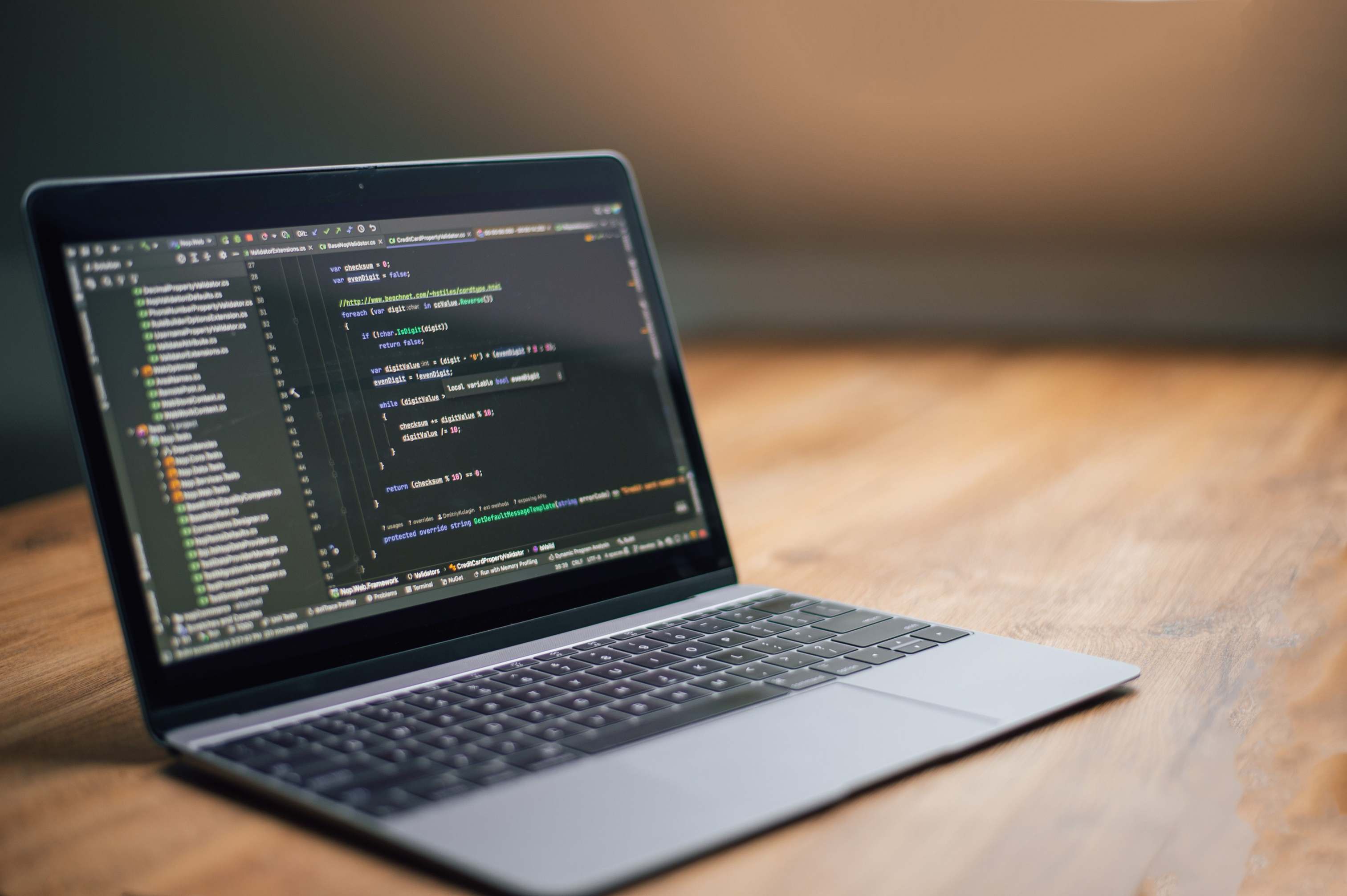Developer laptop with code editor open on a desk, software code on screen